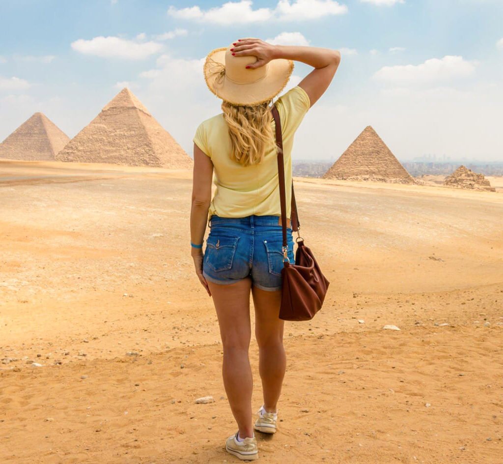 A-great-shot-of-a-solo-female-traveler-in-front-of-the-pyramids